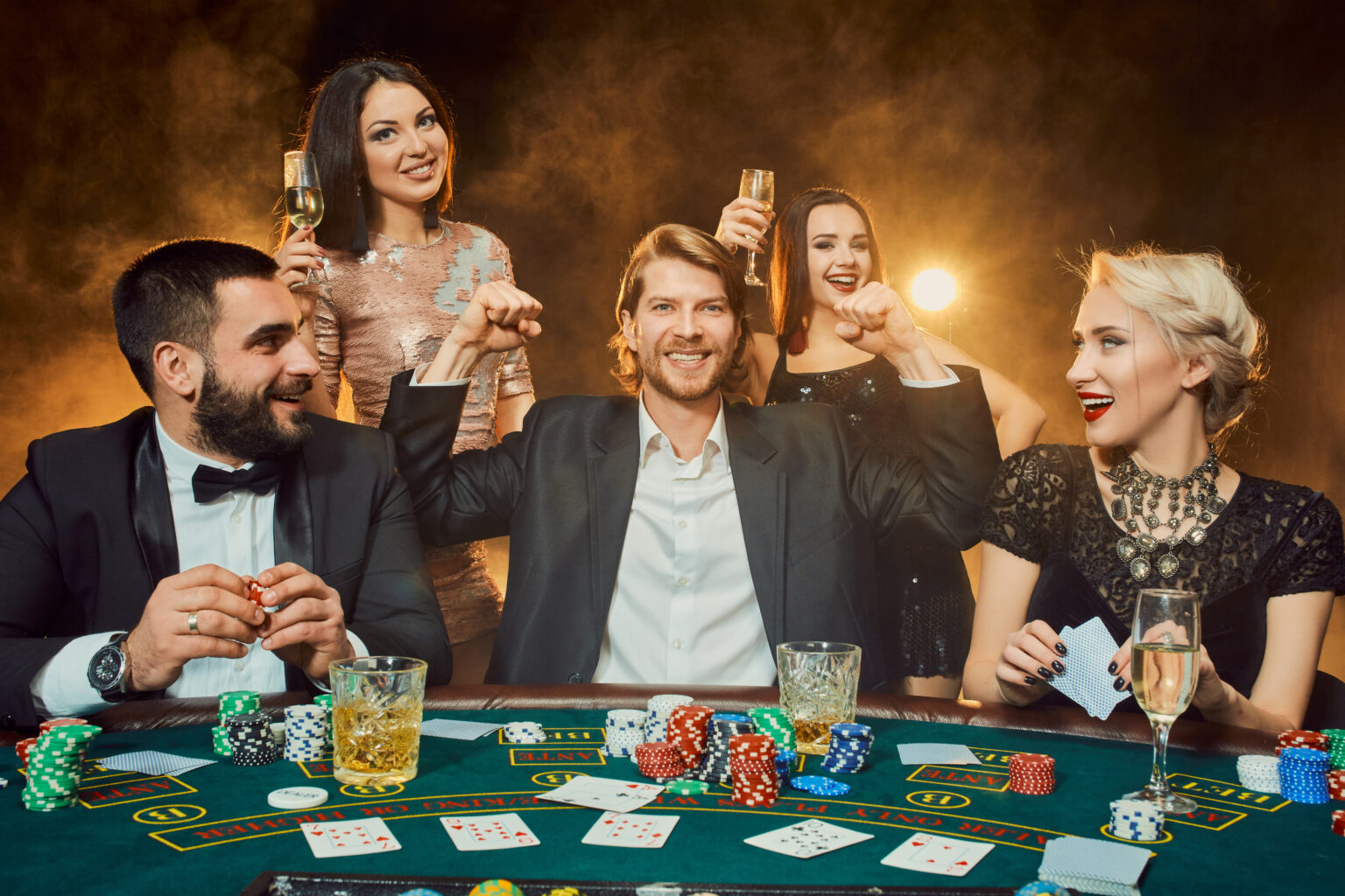 Poker players sitting around a table at a casino.
